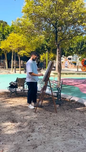 Fer pintando en un caballete al aire libre